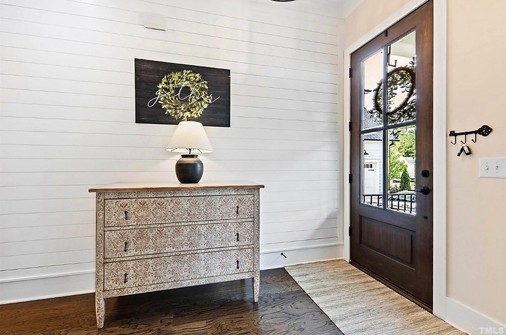 Entryway with antique console and black door