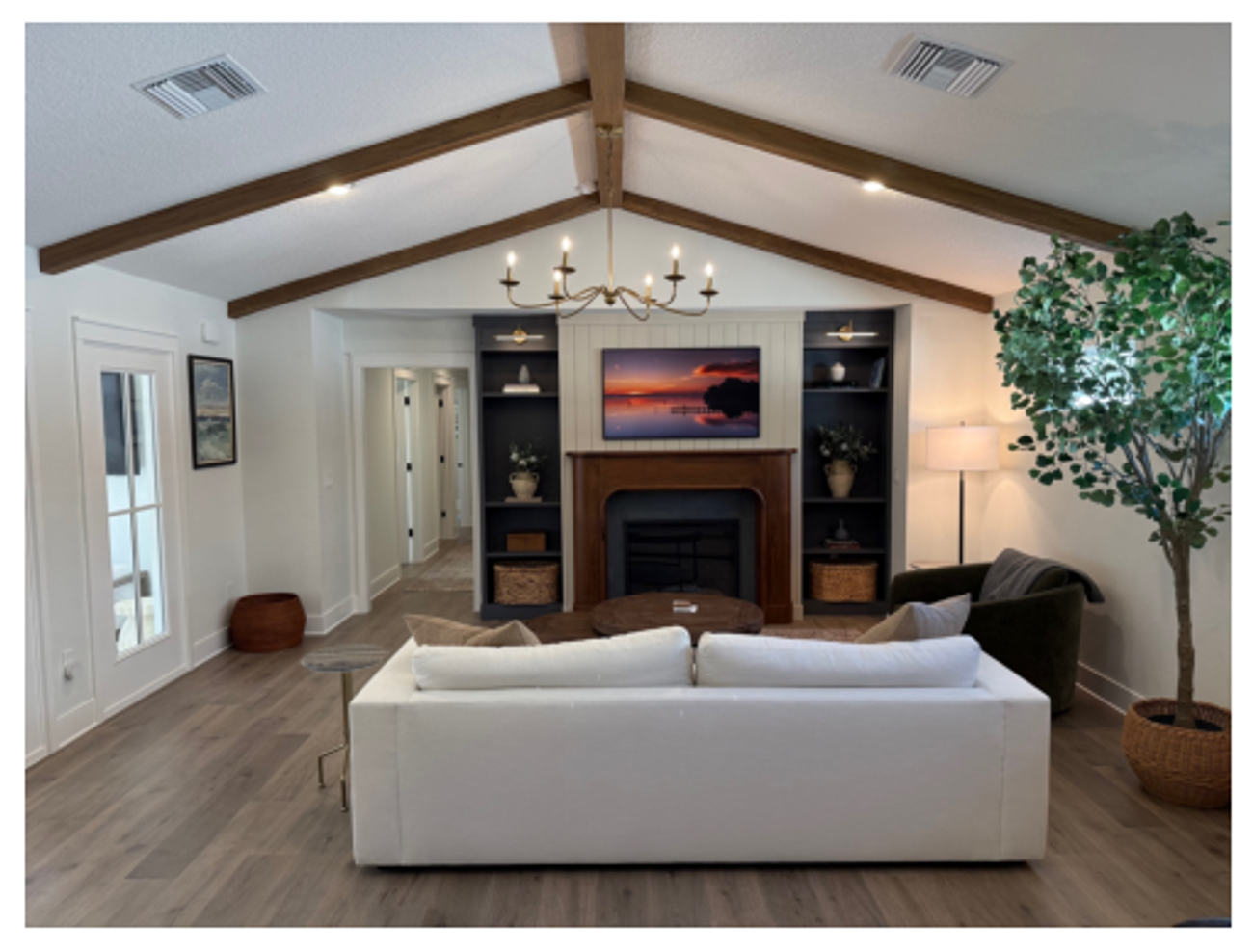 Living room with vaulted beamed ceiling and fireplace