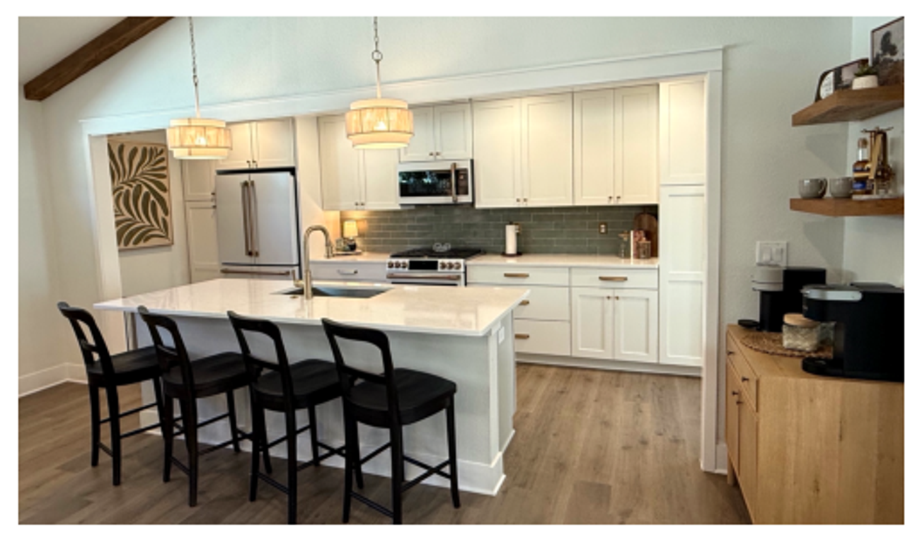 Chef kitchen with quartz island and pendant lights